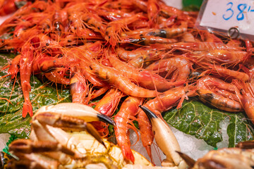 Fresh red shrimp (Aristeus antennatus) in a market in Huelva (Spain), selective focus on the center of the image.
