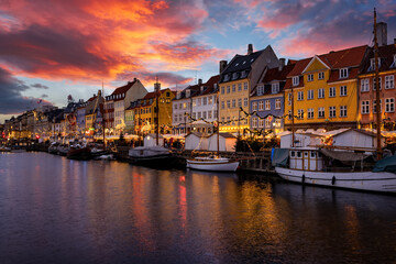 Beautiful winter sunset view of the popular Nyhavn area at Copenhagen, Denmark, decorated for...