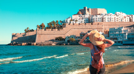 Woman visiting Peniscola city and castle on the beach