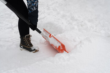 Removing snow from the sidewalk on a cold winter day. Snow shoveling, removal after snowstorm. Snow...