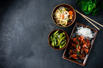 Asian lunch pork with shiitake mushrooms and vegetables, chicken noodle soup with mushrooms and beans.