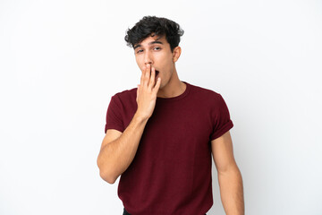 Fototapeta na wymiar Young Argentinian man isolated on white background yawning and covering wide open mouth with hand