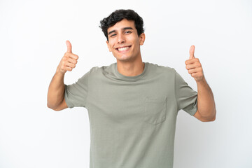 Young Argentinian man isolated on white background giving a thumbs up gesture