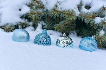 Fototapeta na wymiar blue christmas balls on the snow with fir branches. New Year Christmas.