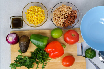 Ingredients for salad with Texas caviar. Vegetable dish with corn, beans, pepper, pepper, tomatoes, beans. Top view