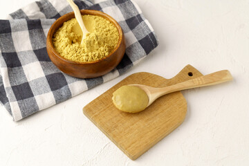 Mustard sauce jar and bowl of powdered mustard. Selective focus