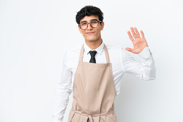 Restaurant Argentinian waiter isolated on white background saluting with hand with happy expression