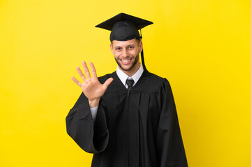 Young university graduate caucasian man isolated on yellow background counting five with fingers