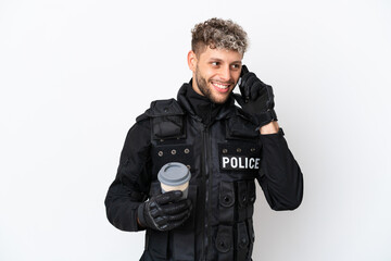 SWAT caucasian man isolated on white background holding coffee to take away and a mobile