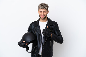 Young man with a motorcycle helmet isolated on white background giving a thumbs up gesture