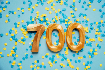 700 seven hundred followers subscriber card golden birthday candle on yellow and blue confetti...