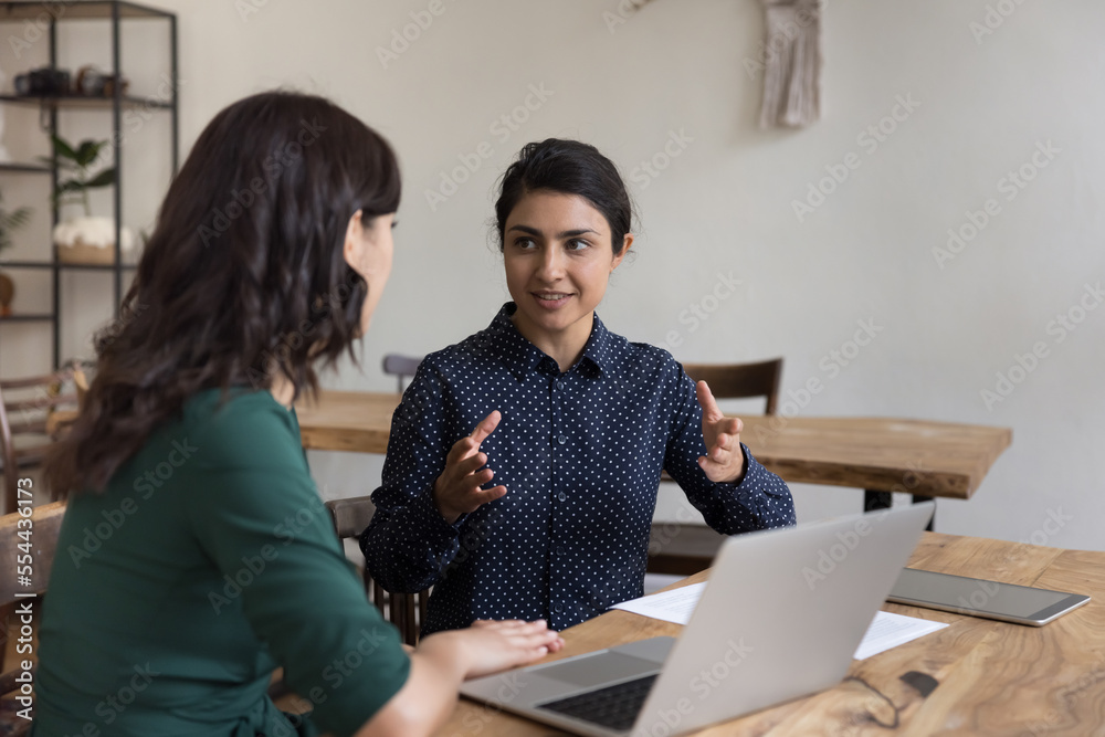 Canvas Prints positive pretty indian mentor woman training intern, new employee, talking to coworker at office wor