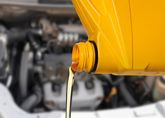Pouring motor oil from yellow container, closeup
