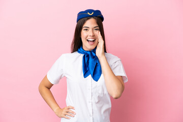 Airplane stewardess Brazilian woman isolated on pink background shouting with mouth wide open