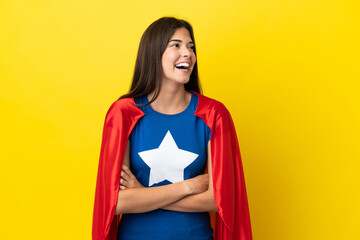 Super Hero Brazilian woman isolated on yellow background happy and smiling