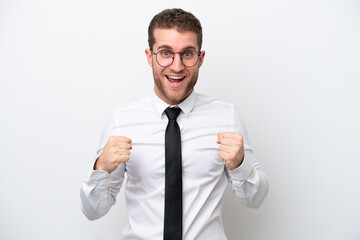 Young business caucasian man isolated on white background celebrating a victory in winner position