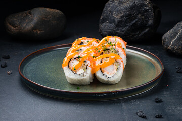 Japanese food Philadelphia rolls with shrimp, salmon, avocado, Philadelphia cheese, nori, rice with mango sauce.