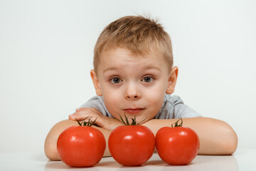 Fototapeta na wymiar Teaching child to healthy and varied vegitarian food. Smiling cute child with vegetables in hands.