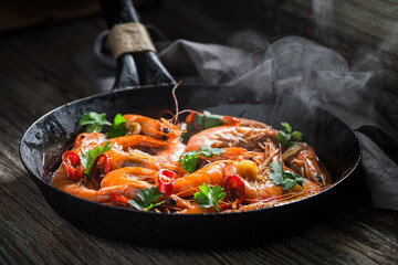 Delicious and hot shrimps on pan with garlic and coriander.