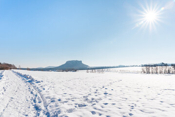 Fototapeta na wymiar winter landscape with snow and footsteps in Saxonian Switzerland