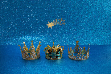Three crowns of the three wise men with star over blue background. For Reyes Magos day and Happy...