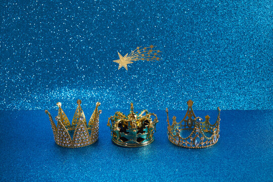 Three crowns of the three wise men with star over blue background. For Reyes Magos day and Happy Epiphany day.