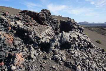 Volcanic landscapes of Lanzarote. Solidified lava, lava chimney, lava tunnel, sea of lava, eruption, canary islands, crater, volcano, black rocks, photographed in November 2022, trekking trip,