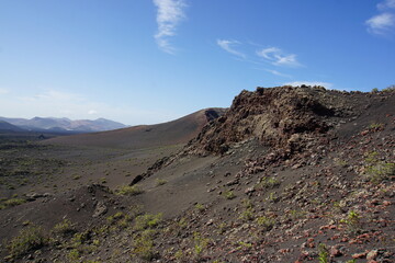 Volcanic landscapes of Lanzarote. Solidified lava, lava chimney, lava tunnel, sea of lava, eruption, canary islands, crater, volcano, black rocks, photographed in November 2022, trekking trip,