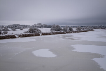 frozen snow and ice covered river Lielupe near Jelgava town in Latvia. Beautiful winter morning