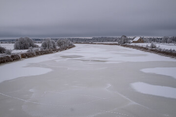 frozen snow and ice covered river Lielupe near Jelgava town in Latvia. Beautiful winter morning