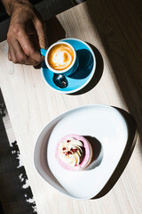 Cup of coffee with milk and cheesecake