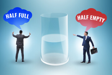 Businessman in half empty half full glass concept
