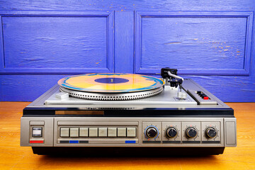 Obraz premium Vintage turntable vinyl record player with blue and orange vinyl