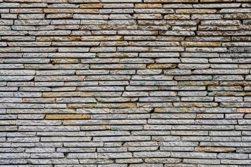 Brick wall texture with cracks and small holes attracts tourists attention with durability and stability over years. Brick wall hides mystery from visitor