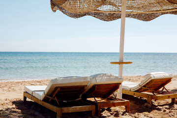 beach with umbrella and chairs