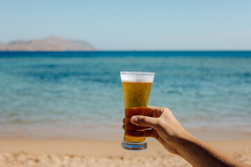 glass of beer on the beach