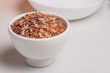 Raw riceberry in white cup.Healthy food.
