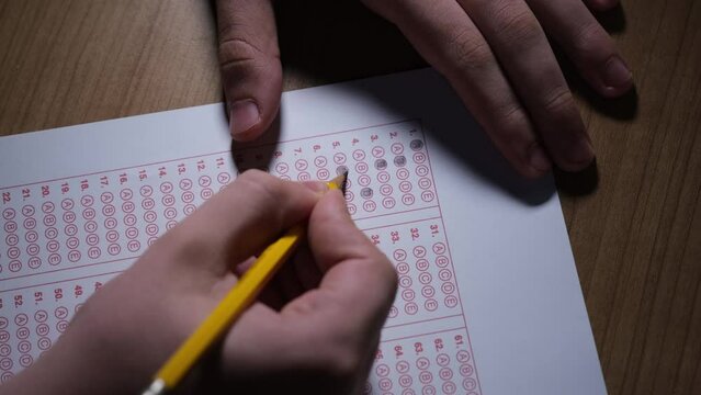A close-up look at filling in the little circles of a answer key paper.