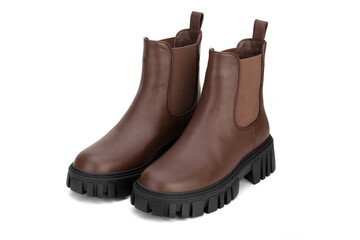 Brown women's leather shoes on a white background. Fashion trend. Winter season half-boots.