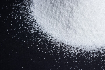 White quartz sand on a black background in the form of a slide.