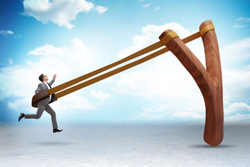 Businessman being launched from slingshot in career concept