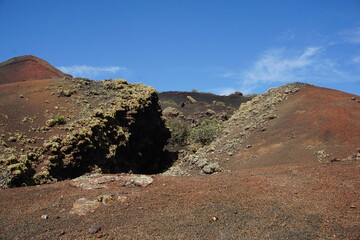 Volcanic landscapes of Lanzarote. Solidified lava, lava chimney, lava tunnel, sea of lava, eruption, canary islands, crater, volcano, black rocks, photographed in November 2022, trekking trip,