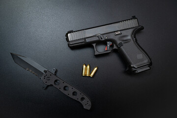 Concealed carry pistol and folding tactical knife.