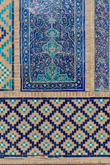 Closeup of ancient building wall with traditional blue pattern on majolica tiles Bukhara Uzbekistan