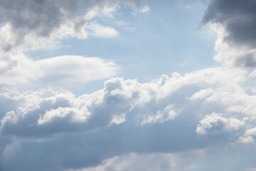 Blue sky and white clouds floated in the sky on a clear day with warm sunshine combined with cool breeze blowing against the body resulting in a miraculous refreshing like paradise.