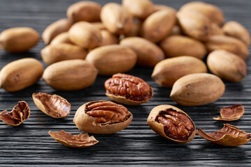 Pecan heap on a black table, selective focus.