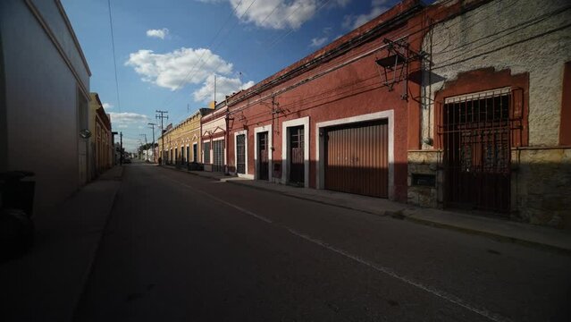 Slow motion push in down a deserted street in Mexico, Merida, Yucatan in early evening.