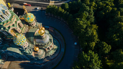 Aerial parallel view of a domes of the Savior on Spilled Blood next to park in the historical and...