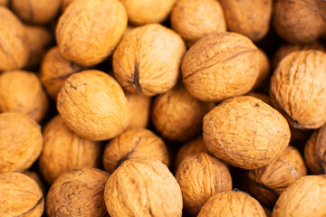 Walnuts with shells. Background of fresh walnuts.