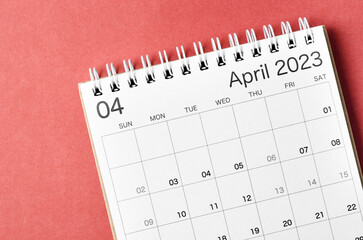 A April 2023 calendar desk for the organizer to plan and reminder isolated on red background.